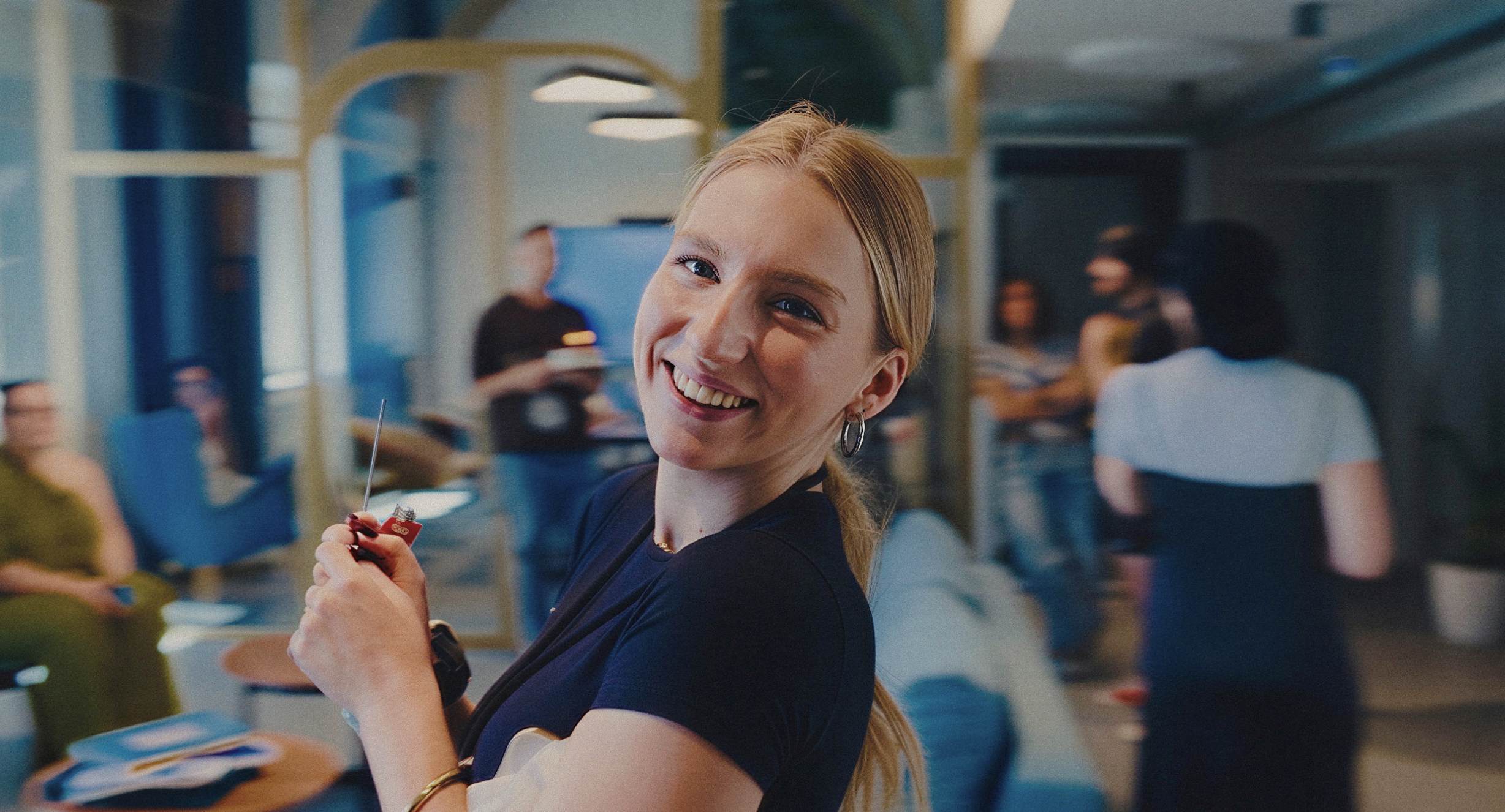 A smiling REBORRN team member in the studio
